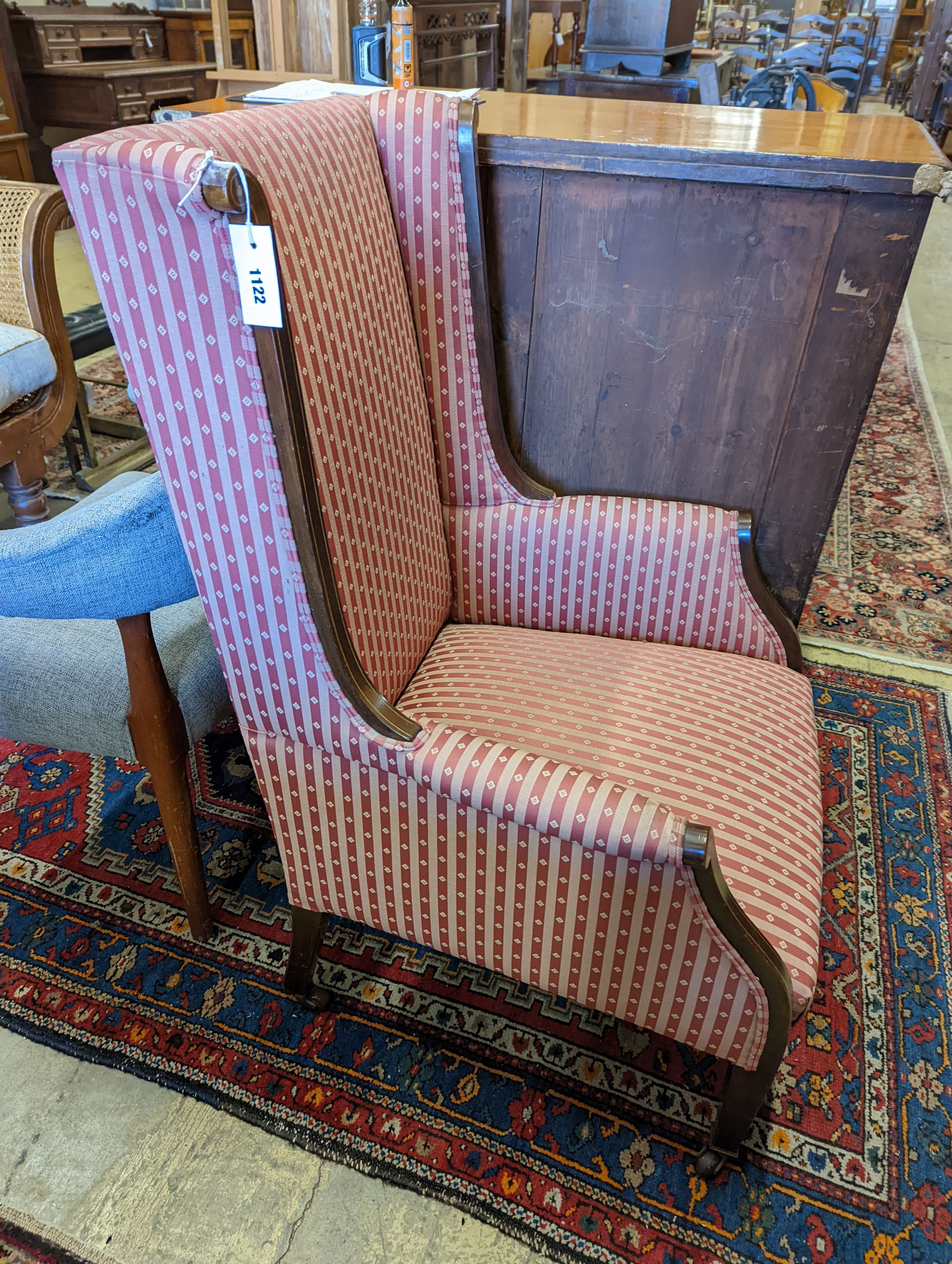 An Edwardian inlaid armchair with scrolled frame